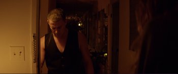 Movie still from “Magic Mike” (2012), directed by Steven Soderbergh – A man with blonde hair standing in a dark room; Medium shot, Low angle