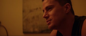 Movie still from “Magic Mike” (2012), directed by Steven Soderbergh – A man's face in a dark room; Close Up shot, Over the shoulder angle