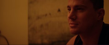 Movie still from “Magic Mike” (2012), directed by Steven Soderbergh – A man's face in the dark; Close Up shot, Over the shoulder angle