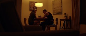 Movie still from “Magic Mike” (2012), directed by Steven Soderbergh – A man and a woman sitting at a dinner table; Medium shot, Low angle