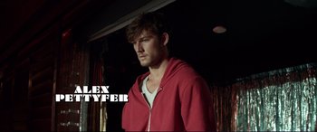 Movie still from “Magic Mike” (2012), directed by Steven Soderbergh – A man wearing a red jacket standing in a room; Medium shot, Low angle