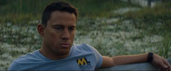 Movie still from “Magic Mike XXL” (2015), directed by Gregory Jacobs – A person sitting on a bench; Close Up shot, High angle
