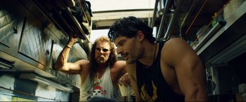 Movie still from “Magic Mike XXL” (2015), directed by Gregory Jacobs – Two men on a bus one of which is talking to another man; Medium shot, Over the shoulder angle