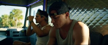 Movie still from “Magic Mike XXL” (2015), directed by Gregory Jacobs – Two young men sitting next to each other on a train; Close Up shot, Low angle