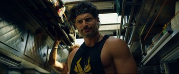 Movie still from “Magic Mike XXL” (2015), directed by Gregory Jacobs – A man with a beard wearing a tank top; Close Up shot, Over the shoulder angle
