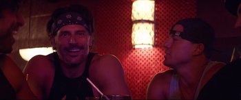 Movie still from “Magic Mike XXL” (2015), directed by Gregory Jacobs – A man and a woman sitting at a table in front of a lamp; Close Up shot, Over the shoulder angle