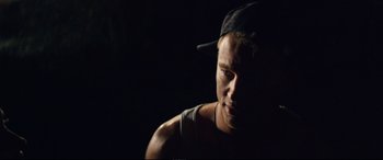 Movie still from “Magic Mike XXL” (2015), directed by Gregory Jacobs – A young man wearing a baseball cap is looking at the camera; Close Up shot, Low angle