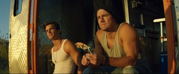 Movie still from “Magic Mike XXL” (2015), directed by Gregory Jacobs – Two young men sitting next to each other; Medium shot, Low angle