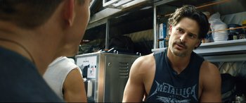 Movie still from “Magic Mike XXL” (2015), directed by Gregory Jacobs – A man sitting next to another man in front of an oven; Close Up shot, Over the shoulder angle