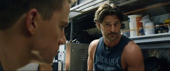 Movie still from “Magic Mike XXL” (2015), directed by Gregory Jacobs – A man in a black shirt is talking to another man; Close Up shot, Over the shoulder angle