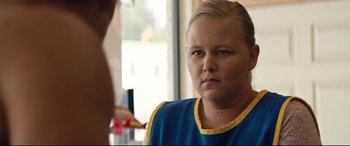 Movie still from “Magic Mike XXL” (2015), directed by Gregory Jacobs – A woman in a blue and yellow shirt is looking at the camera; Close Up shot, Over the shoulder angle