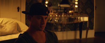Movie still from “Magic Mike XXL” (2015), directed by Gregory Jacobs – A person wearing a hat; Close Up shot, Over the shoulder angle