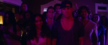 Movie still from “Magic Mike XXL” (2015), directed by Gregory Jacobs – A group of young people standing in a room; Medium shot, Over the shoulder angle