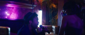 Movie still from “Magic Mike XXL” (2015), directed by Gregory Jacobs – A man with a microphone in his mouth; Medium shot, Over the shoulder angle