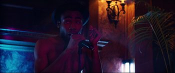 Movie still from “Magic Mike XXL” (2015), directed by Gregory Jacobs – A man with a hat and a microphone in his hand; Medium shot, Low angle