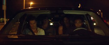 Movie still from “Magic Mike XXL” (2015), directed by Gregory Jacobs – A group of people sitting in the back of a car at night; Medium shot, High angle