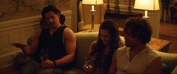 Movie still from “Magic Mike XXL” (2015), directed by Gregory Jacobs – A man and a woman sitting next to each other on a couch; Medium shot, Over the shoulder angle