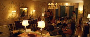 Movie still from “Magic Mike XXL” (2015), directed by Gregory Jacobs – A group of people sitting in a living room; Wide shot, High angle