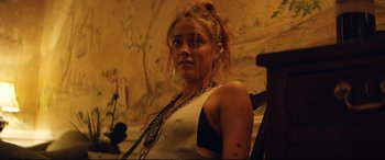 Movie still from “Magic Mike XXL” (2015), directed by Gregory Jacobs – A woman with tattoos is posing for a picture; Close Up shot, Low angle