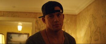 Movie still from “Magic Mike XXL” (2015), directed by Gregory Jacobs – A person wearing a hat; Close Up shot, Over the shoulder angle