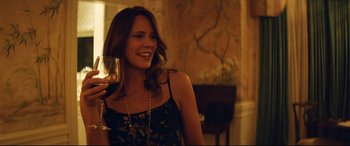 Movie still from “Magic Mike XXL” (2015), directed by Gregory Jacobs – A beautiful woman holding a glass of wine; Medium shot, Over the shoulder angle