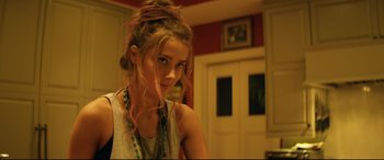 Movie still from “Magic Mike XXL” (2015), directed by Gregory Jacobs – A young woman with long hair and a messy top knot; Close Up shot, Over the shoulder angle