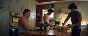 Movie still from “Magic Mike XXL” (2015), directed by Gregory Jacobs – Two men are preparing a meal in the kitchen; Medium shot, Low angle