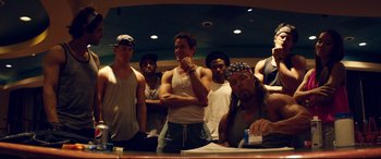 Movie still from “Magic Mike XXL” (2015), directed by Gregory Jacobs – A group of men standing next to each other in a room; Medium shot, Low angle