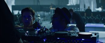 Movie still from “Magic Mike XXL” (2015), directed by Gregory Jacobs – A man wearing a hat is talking to another man in a bar; Medium shot, Over the shoulder angle