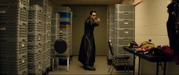 Movie still from “Magic Mike XXL” (2015), directed by Gregory Jacobs – A man in a black leather jacket standing in a room; Wide shot, Low angle