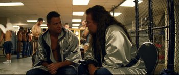 Movie still from “Magic Mike XXL” (2015), directed by Gregory Jacobs – Two men sitting on a bench talking to each other; Medium shot, Over the shoulder angle