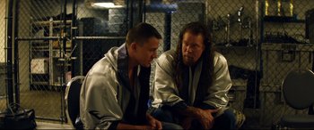 Movie still from “Magic Mike XXL” (2015), directed by Gregory Jacobs – A couple of men sitting next to each other; Medium shot, Over the shoulder angle