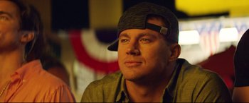 Movie still from “Magic Mike XXL” (2015), directed by Gregory Jacobs – A person wearing a hat; Close Up shot, Over the shoulder angle
