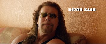 Movie still from “Magic Mike XXL” (2015), directed by Gregory Jacobs – A person with long hair wearing sunglasses; Close Up shot, Low angle