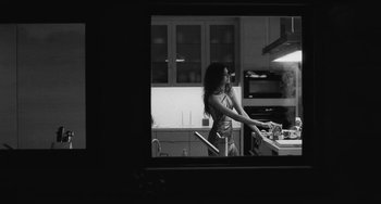 Movie still from “Malcolm & Marie” (2021), directed by Sam Levinson – A black and white photo of a woman in the kitchen; Medium shot, Low angle