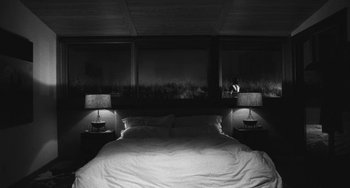 Movie still from “Malcolm & Marie” (2021), directed by Sam Levinson – A bed room with a bed and two night stands; Wide shot, High angle