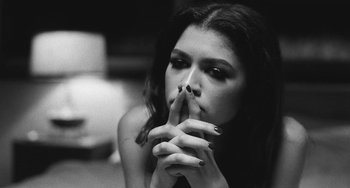 Movie still from “Malcolm & Marie” (2021), directed by Sam Levinson – A woman with her hands over her mouth; Close Up shot, Low angle