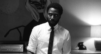 Movie still from “Malcolm & Marie” (2021), directed by Sam Levinson – A black and white photo of a man wearing a shirt and tie; Close Up shot, Low angle