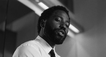 Movie still from “Malcolm & Marie” (2021), directed by Sam Levinson – A black and white photo of a man with a beard; Close Up shot, Low angle