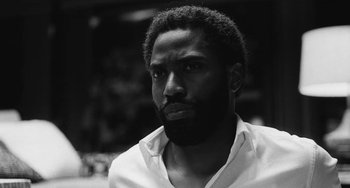 Movie still from “Malcolm & Marie” (2021), directed by Sam Levinson – A black and white photo of a man with a beard; Close Up shot, Low angle