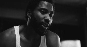 Movie still from “Malcolm & Marie” (2021), directed by Sam Levinson – A black and white photo of a man with a beard; Close Up shot, Low angle