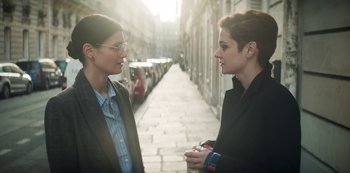 Movie still from “Marianne” (2019), created by Samuel Bodin – Two women standing next to each other on the sidewalk; Medium shot, Over the shoulder angle