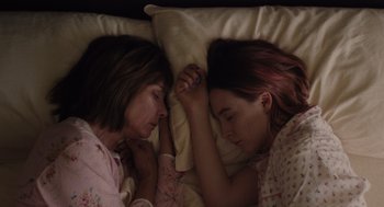 Movie still from “Lady Bird” (2017), directed by Greta Gerwig – Two women are sleeping in a bed together; Close Up shot, Overhead angle