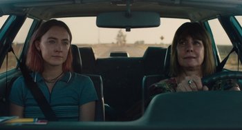 Movie still from “Lady Bird” (2017), directed by Greta Gerwig – Two women sitting in the back seat of a car; Medium shot, Over the shoulder angle