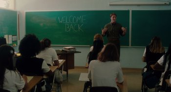 Movie still from “Lady Bird” (2017), directed by Greta Gerwig – A man standing in front of a class with a chalkboard; Wide shot, Over the shoulder angle