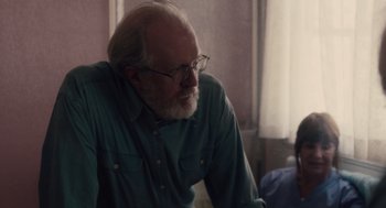 Movie still from “Lady Bird” (2017), directed by Greta Gerwig – An older man wearing glasses and a green shirt; Close Up shot, Over the shoulder angle
