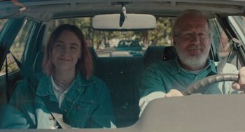 Movie still from “Lady Bird” (2017), directed by Greta Gerwig – A man and a woman sitting in the back seat of a car; Medium shot, Over the shoulder angle