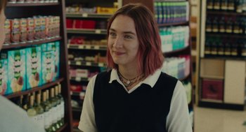 Movie still from “Lady Bird” (2017), directed by Greta Gerwig – A woman with pink hair standing in a store; Medium shot, Over the shoulder angle