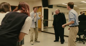Movie still from “Lady Bird” (2017), directed by Greta Gerwig – Two men and a woman are talking in a room; Medium shot, Over the shoulder angle