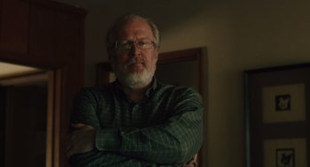 Movie still from “Lady Bird” (2017), directed by Greta Gerwig – An older man wearing glasses and a green shirt; Close Up shot, Over the shoulder angle